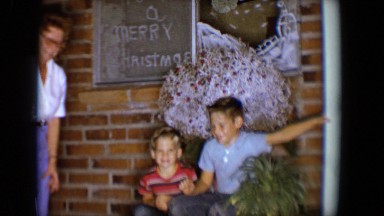 1958: children great christmas visitors at the front door to welcome them
