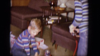 1958: two boys playing with battery-operated christmas presents in front of tree