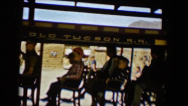 1958: mom and children on the ride wave to someone watching in the crowd TUCSON,