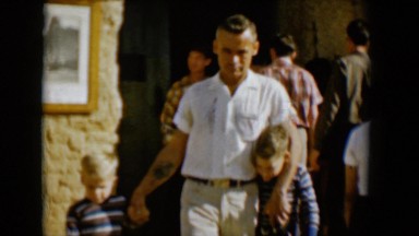 1958: a handsome young father walking with his arms around his two boys TUCSON,