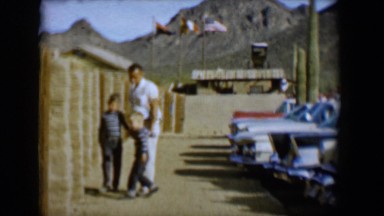 1958: man with children in parking lot in front of mountain TUCSON, ARIZONA