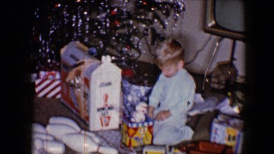 1959: boys, wearing pajamas, playing with their newly opened toys