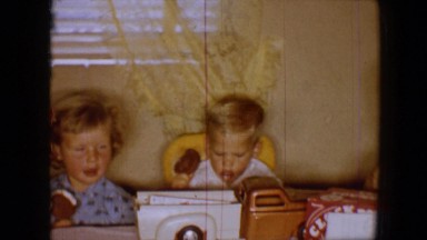 1959: little children eating popsicles at table indoors DISNEYLAND, CALIFORNIA