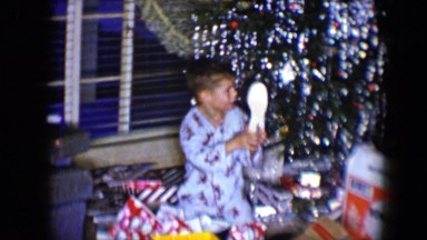 1959: a christmas tree is seen with a child opening presents DISNEYLAND,