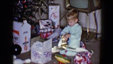 1959: pajama wearing brothers rapidly open their christmas gifts DISNEYLAND,
