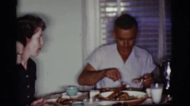 1968: family sitting together and eating a traditional sunday dinner COTTONWOOD,
