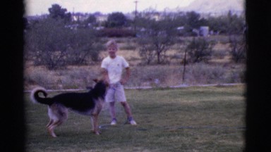 1968: the boy playing with the dog COTTONWOOD, ARIZONA