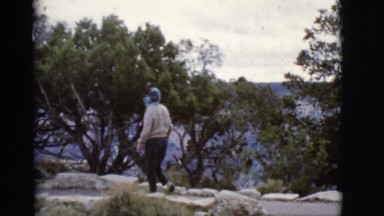 1968: carefully treading over the rocky terrain on the edge of a cliff the woman