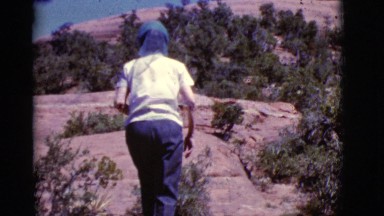 1968: a woman walking or climbing to the hill COTTONWOOD, ARIZONA
