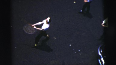 1956: group of men in the middle of a city street playing an imprompt game