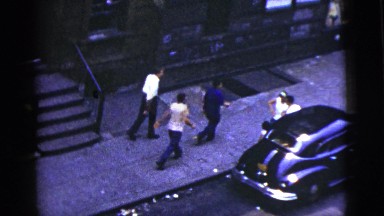 1956: husband drinking and smoking and his wife stands beside NEW YORK CITY