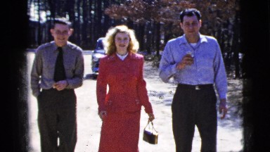 1956: group in formalwear approaches, smiling, before called by distant man