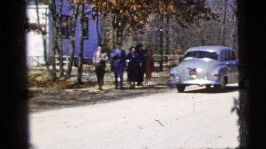 1956: family walking past car while leaving church NEW YORK CITY