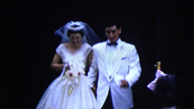 1962: newlyweds walking out of church followed by smiling wedding party NEW YORK