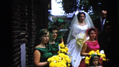 1962: the bride, groom, bridesmaids and groomsmen standing to take outdoor