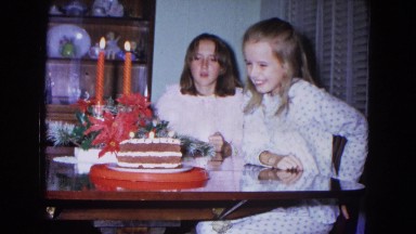 1967: girl blowing out candles on birthday cake. NEVADA