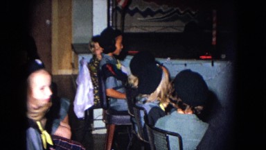 1967: uniformed children watch santa claus decorate small tree on stage NEVADA
