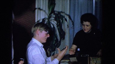 1967: a group of people looking at pictures and playing a board game