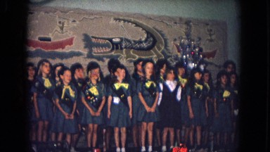 1967: a group of young girls on stage dressed in what appears to be girl scout