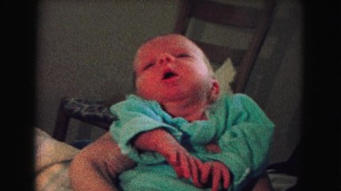 1967: yawning baby in blue dress in the hand of it's mother NEVADA
