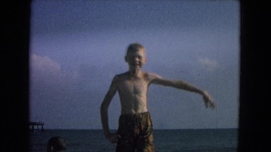 1967: Boy on Beach Watching Others in Ocean on Rafts Nevada