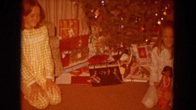 1967: two young girls smiling and laughing on christmas morning