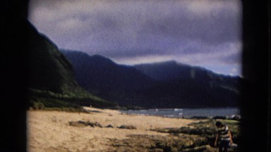 1967: three people with a pet walking on a rocky coast area NEVADA