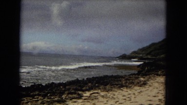 1967: scenic view of ocean, mountains, sky and sandy beaches, and the tide