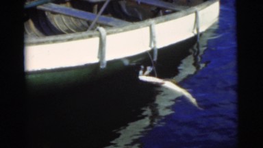 1956: man gets into the boat in a snap NEW YORK CITY