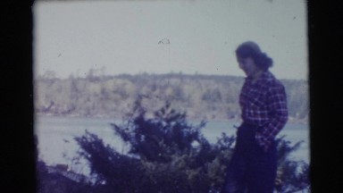 1956: a fair lady wearing shirt, pant and putting her hands in pocket enjoying