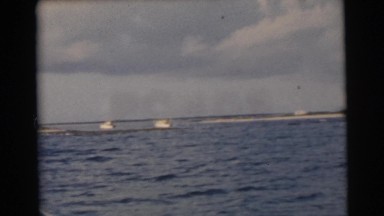 1956: boats on the ocean near the shoreline as seen from a moving vessel FLORIDA