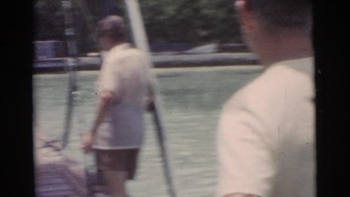 1956: men on a wooden fishing dock inspecting their large catch of the day