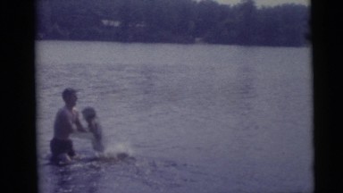 1967: Father Lifting Child Out of Lake in Camden, New Jersey