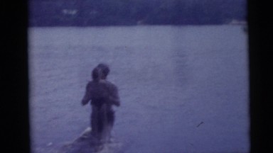 1967: man splashing a boy in the lake CAMDEN, NEW JERSEY
