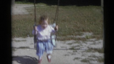 1967: girl swing and boy on seesaw CAMDEN, NEW JERSEY