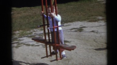 1967: kids swinging in different swings in a children's park CAMDEN, NEW JERSEY