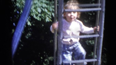 1967: little girl makes faces and climbs on a slide CAMDEN, NEW JERSEY
