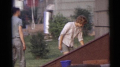1967: a man and a woman walking around a building and inspecting CAMDEN