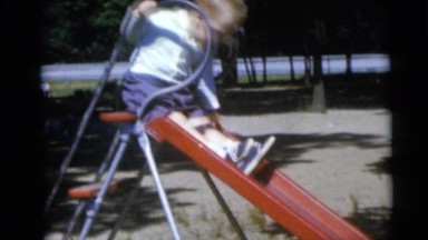 1967: the boy playing in a park in front of their parents CAMDEN, NEW JERSEY