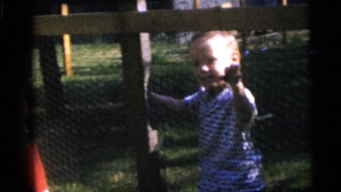 1967: kids behind a fence. CAMDEN, NEW JERSEY