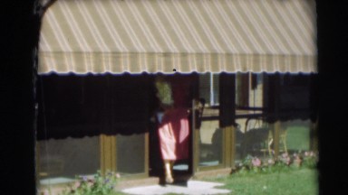 1954: Cute Toddler Running Away from Mother in Post-War Suburban Yard