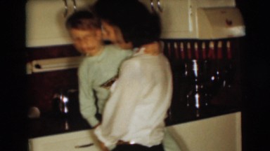 1954: mother and child in the kitchen near to a refrigerator PENNINGTON
