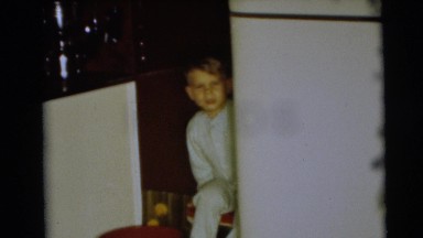 1967: child in pajamas peeks from behind fridge CAMDEN, NEW JERSEY