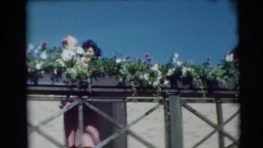 1954: mother and son smelling the flowers on a gorgeous day. PENNINGTON