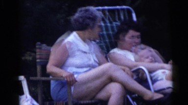 1967: People Talking and Relaxing Outdoors in Lounge Chairs Lady Walks Away