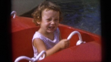1967: Smiling Girl and Frowning Boy Pretend to Steer Boat Amusement Ride Camden