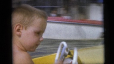 1954: Adults Watching Children Go Around in Boats Pennington, New Jersey