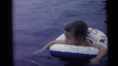 1967: woman and children playing in the water and sand CAMDEN, NEW JERSEY