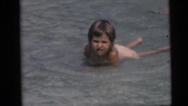 1967: Children Swimming and Playing in Shallow Water on the Beach