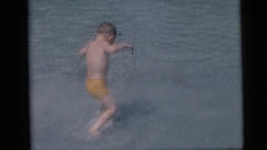 1967: playing children on the beach of the sea in the rain CAMDEN, NEW JERSEY